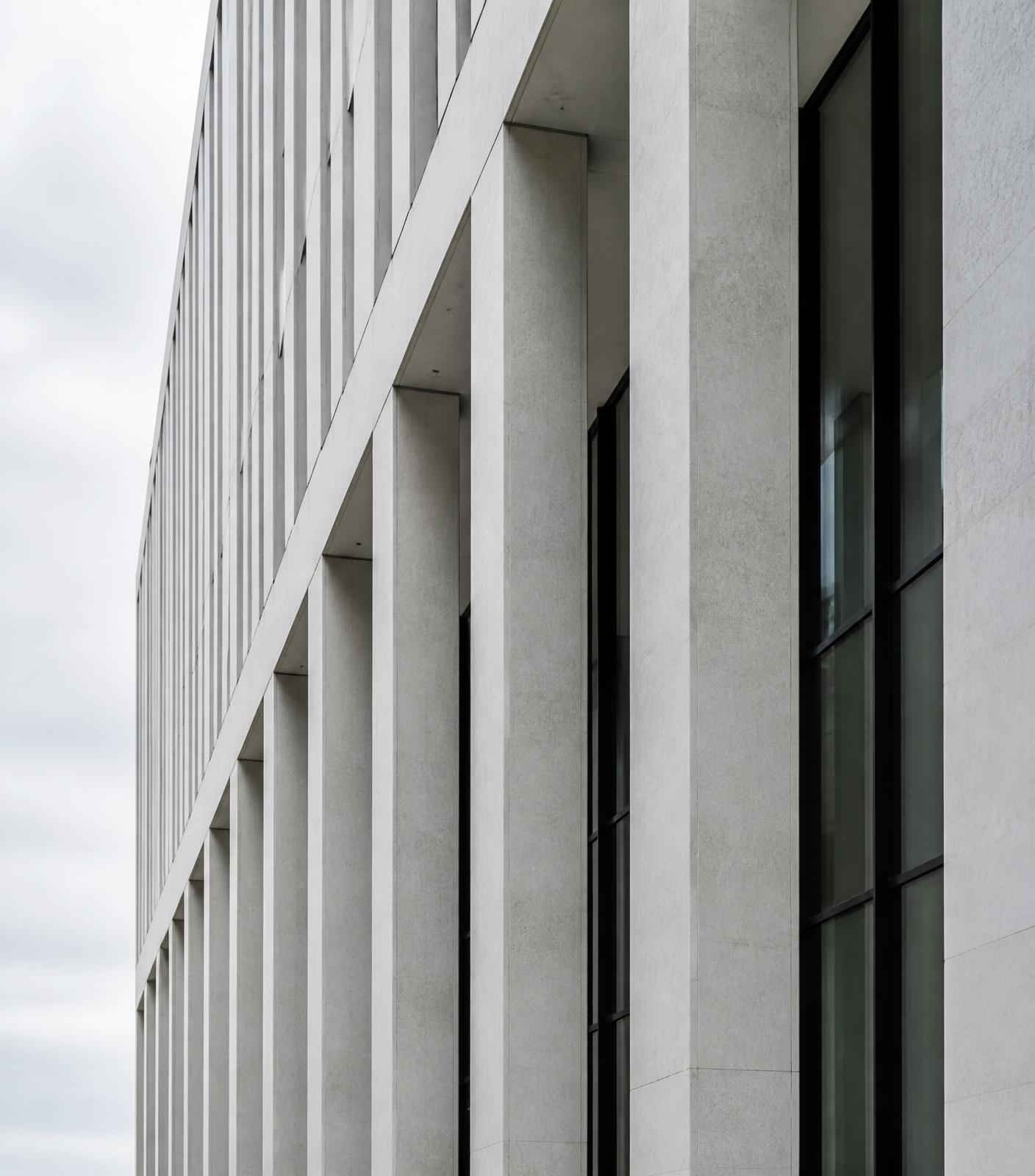 Repeating concrete and glass colonnade of a modern institutional building